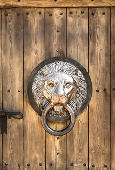 Antique door knocker shaped like a lion's head.