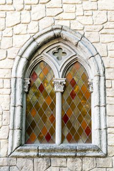 Window in medieval style with colored glasses.