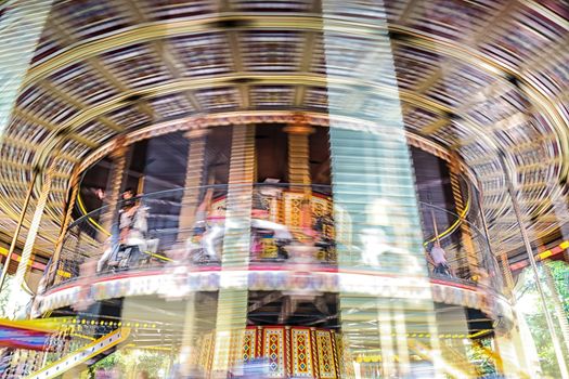 Motion blurr of vintage merry-go-round carousel.