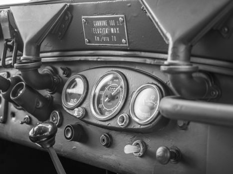 Dashboard of an old green military jeep.