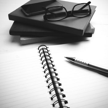 notepad with stack of book on table black and white tone color style