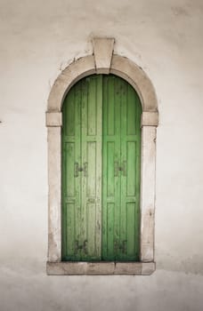 Ancient stone window with green wooden balcony