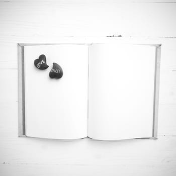 heart on notebook over white table black and white tone color style