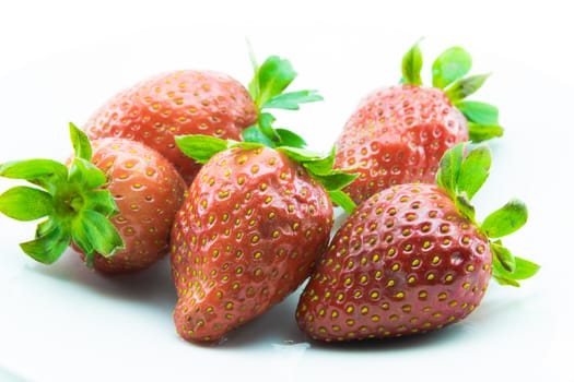 red strawberries freshly picked on white background