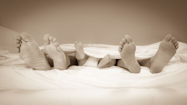 the feet of the family out of the bed sheet