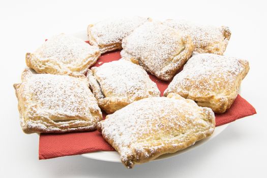 handmade biscuits of puff pastry stuffed with chocolate and covered with powdered sugar