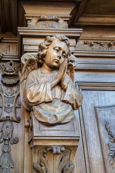 Detail of a carved wooden portal of an italian church.