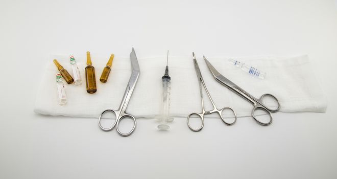 composition with surgical instruments, syringe and medicines