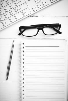 computer and notepad over white table black and white tone color style