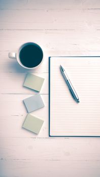 notepad and coffee cup on white table view from above vintage style