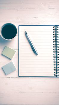 notepad and coffee cup on white table view from above vintage style