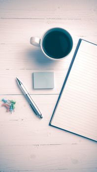 notepad and coffee cup on white table view from above vintage style