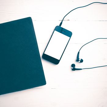 cellphone and notebook over white table vintage style