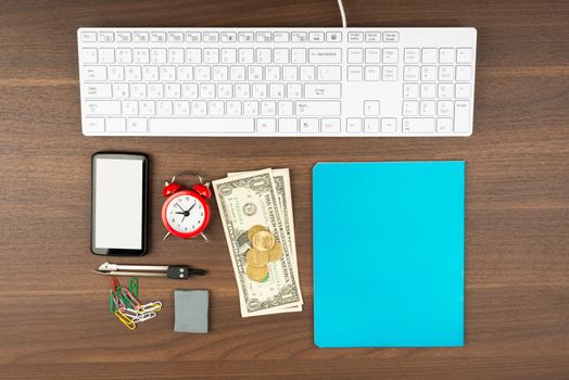 Cash with office supplies on wooden table