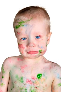 little boy soiled with paint and very upset