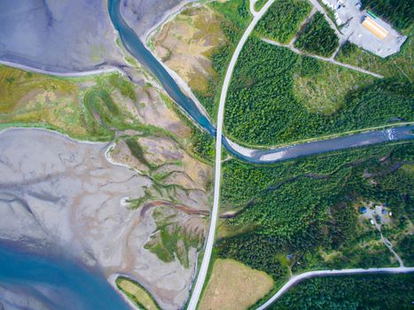 Top down aerial view of road passing through river delta in Norway