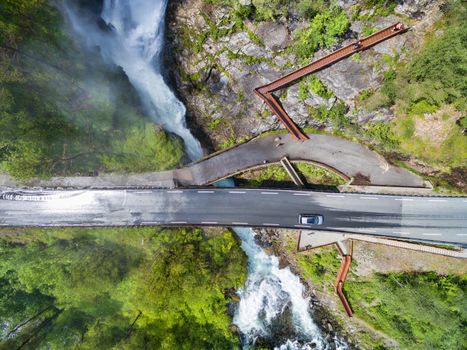 Aerial view af small bridge over waterfall in Norway