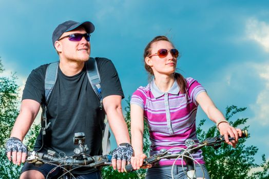 Portrait of a young cyclist in sunglasses looking to the side