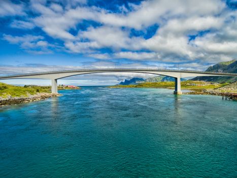 Modern bridge spanning narrow fjord in Norway