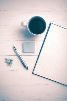 notepad and coffee cup on white table view from above vintage style