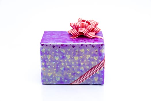 pink gift box with red ribbon bow, isolated on white