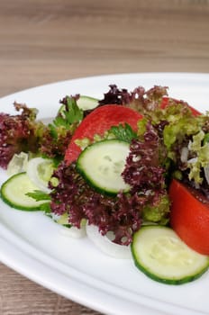 Light salad of lettuce and tomatoes with cucumber