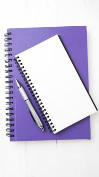 notebook and pen over white table