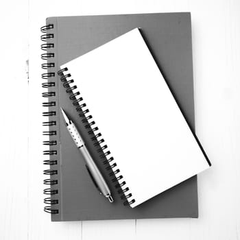 notebook and pen over white table black and white tone color style