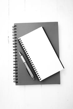 notebook and pen over white table black and white tone color style