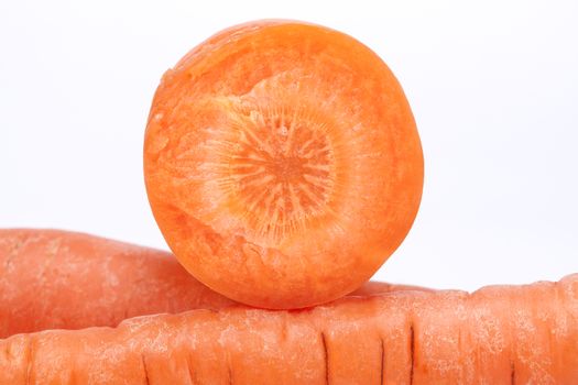 cut carrot on white background, close up.