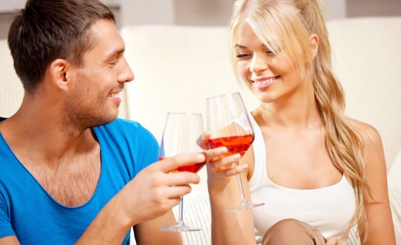 picture of happy romantic couple drinking wine, focus on woman