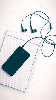 notepad and cellphone over white table vintage style