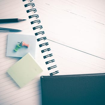 brown notebook with office supplies on white table view from above vintage style