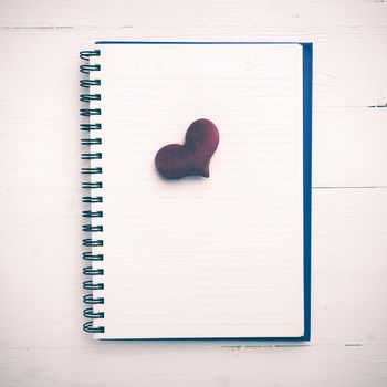 red heart on notepad on white table vintage style