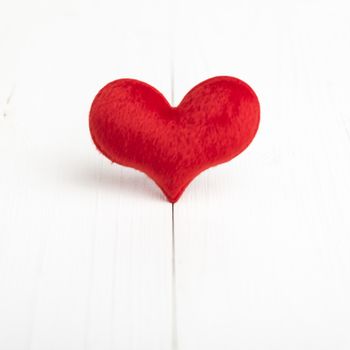 red heart on white table