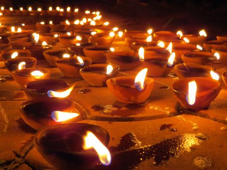Traditional earthen lamps lit with oil, on the ocassion of Diwali festival in India.