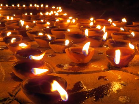 Traditional earthen lamps lit with oil, on the ocassion of Diwali festival in India.