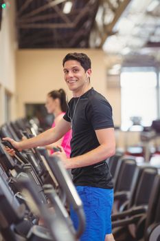 Fit people working out using machines at the gym