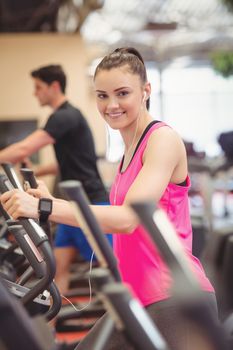 Fit people working out using machines at the gym