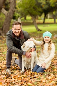 Young family with a dog on an autumns day