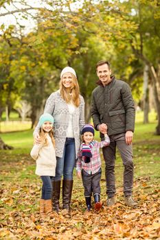 Portrait of a smiling young family on an autumns day