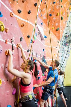 Fit people ready to rock climb at the gym