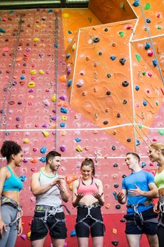 Fit people getting ready to rock climb at the gym