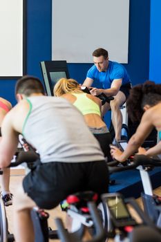 Fit people in a spin class at the gym