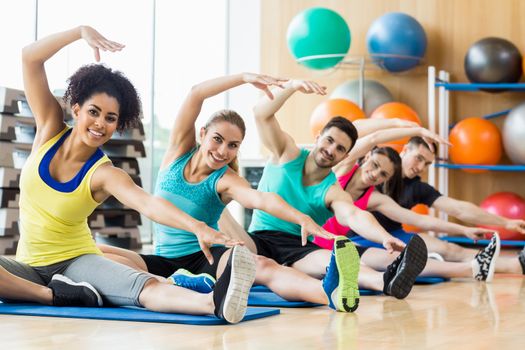 Fitness class exercising in the studio at the gym