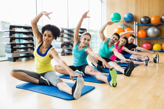 Fitness class exercising in the studio at the gym