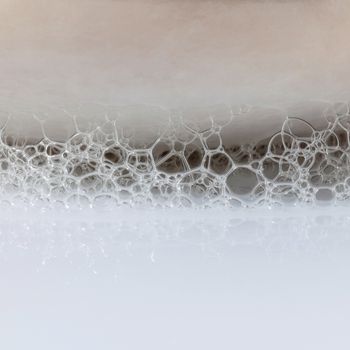 Herbal spa soap bar on white bath towel with thyme,rosemary and luffa isolated on white background.