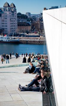 OSLO - MARCH 21: People hanging around in Opera house in Oslo. The building is designed by Snohetta company