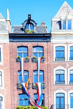 Decorated medieval facade in Amsterdam the Netherlands at kings day