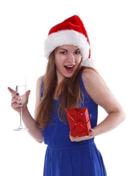 girl in a red Christmas hat with a gift and a glass of champagne on a white background. Isolate.